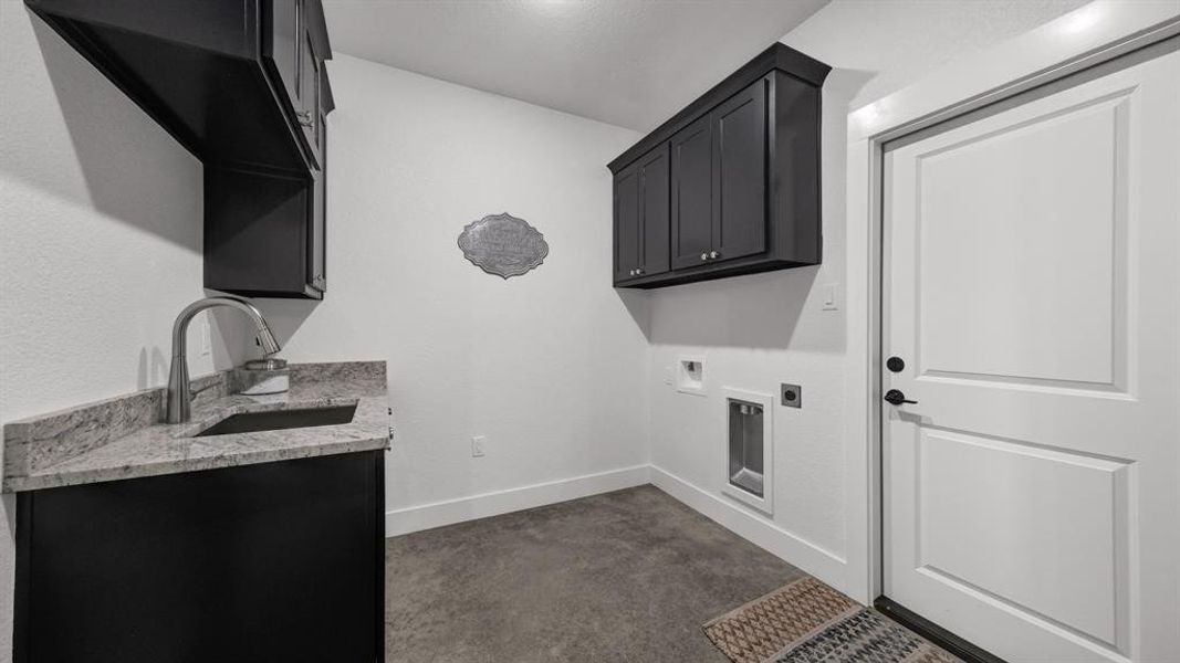 Handy counter space in a dedicated utility room with plenty of cabinet storage.