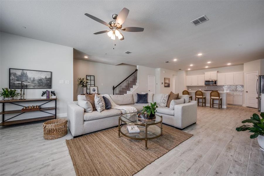 Open-concept design highlights a generous quartz island, ample cabinetry, and an easy flow between living and dining areas.