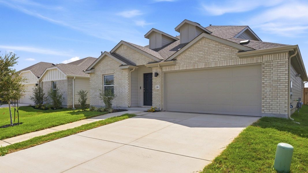 Front exterior of a new home in Sky Ridge, San Marcos, TX, highlighting curb appeal (Image 21). Front exterior of a new home in Sky Ridge, San Marcos, TX, highlighting curb appeal (Image 21).