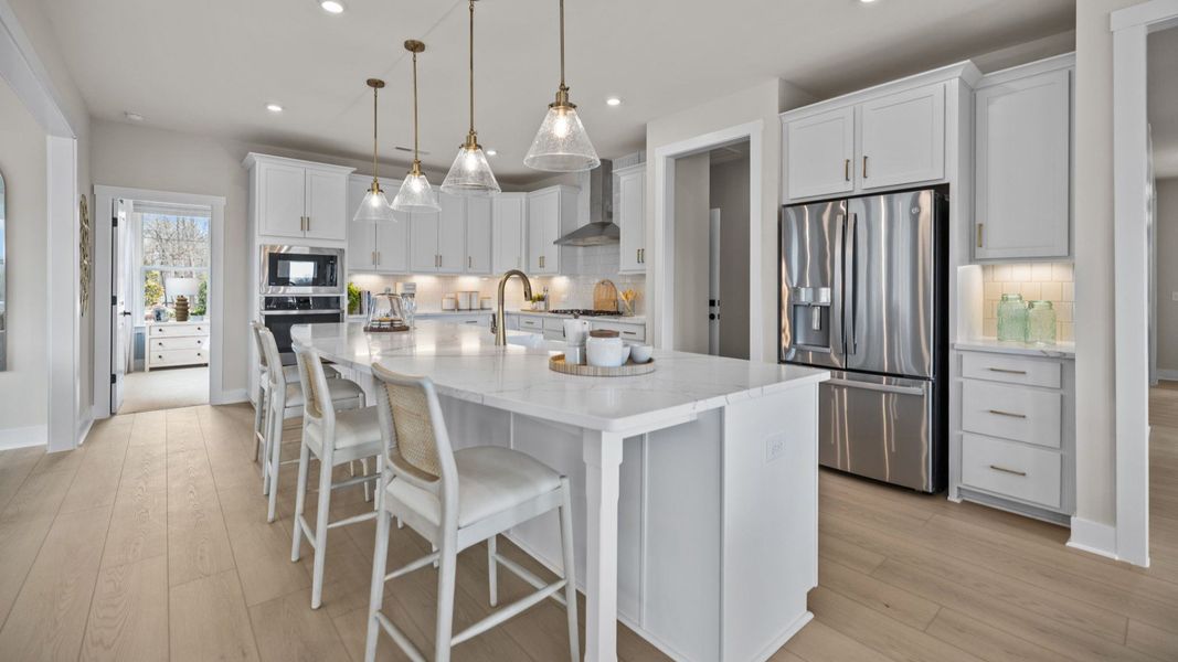 The Stonefield Home Plan by DRB Homes in Belmont, NC. - Kitchen featuring an oversized bar and butler's panty