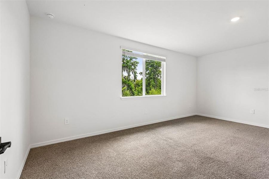 Spacious, unfurnished interior of a new home in The Grove at Stuart Crossing - Signature Series, Bartow (Image 18).