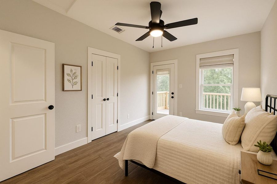 Bedroom featuring access to outside, wood finished floors, a ceiling fan, and a closet