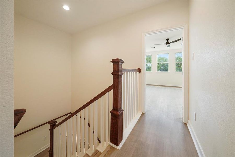 Second floor landing and hallway to primary bedroom, guest bedrooms, bath and laundry room.