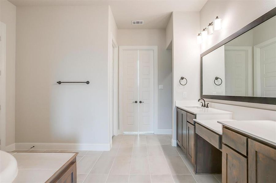 Bathroom with vanity and tile patterned floors