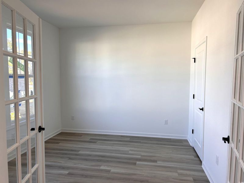 Empty room with wood finished floors and french doors