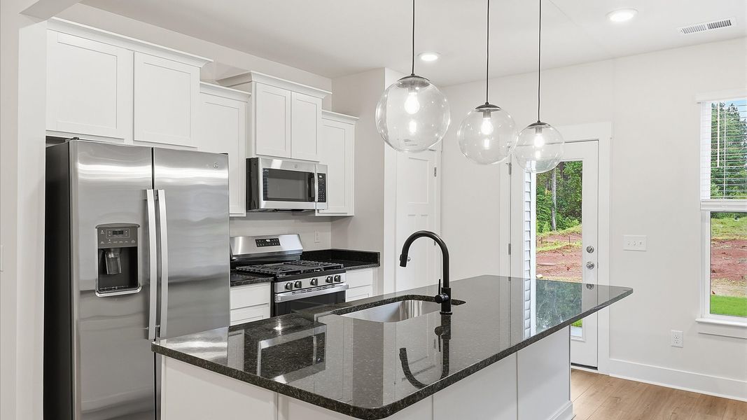 Tasteful kitchen with a streamlined island and modern finishes in a first-class DRB Homes design