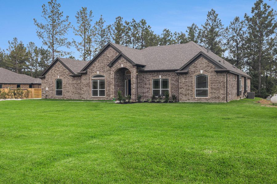 Front exterior of a new home in Deer Pines, Conroe, TX, highlighting curb appeal (Image 2).