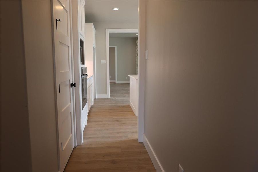 Corridor with light wood-type flooring