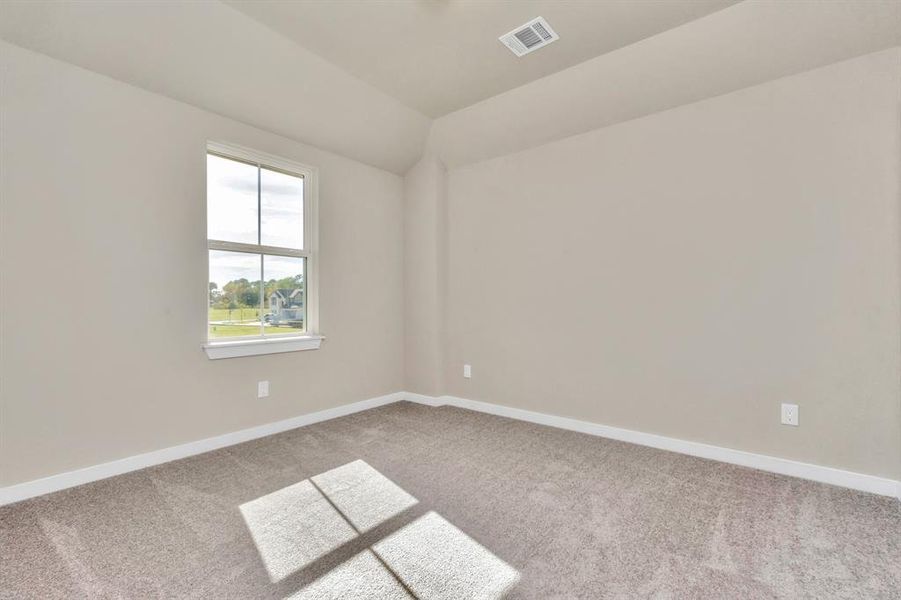 Secondary bedrooms showcase 5-panel doors adorned with modern hardware, large windows enhanced by privacy blinds, and spacious closets featuring sleek and contemporary finishes. Sample photo of completed home with similar floor plan. As-built interior colors and selections may vary.