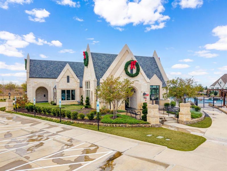 View of front of property with stone siding and an outdoor pool