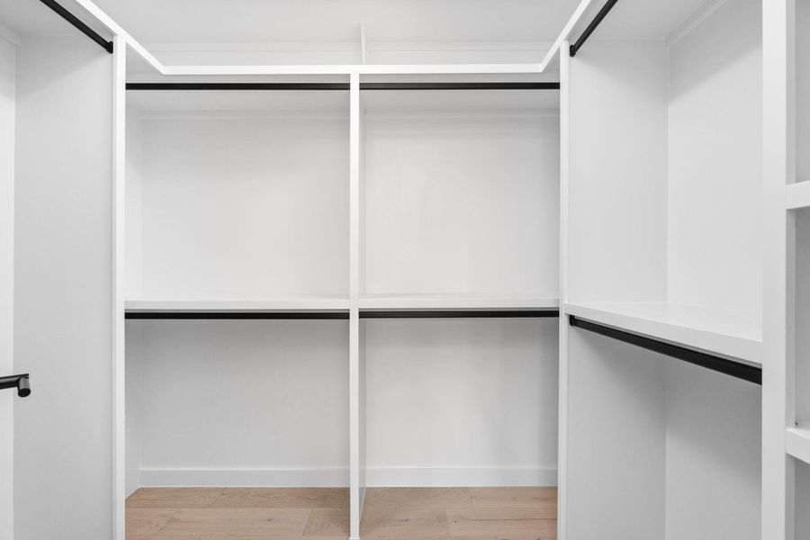 Spacious closet with wood finished floors Spacious closet with wood finished floors