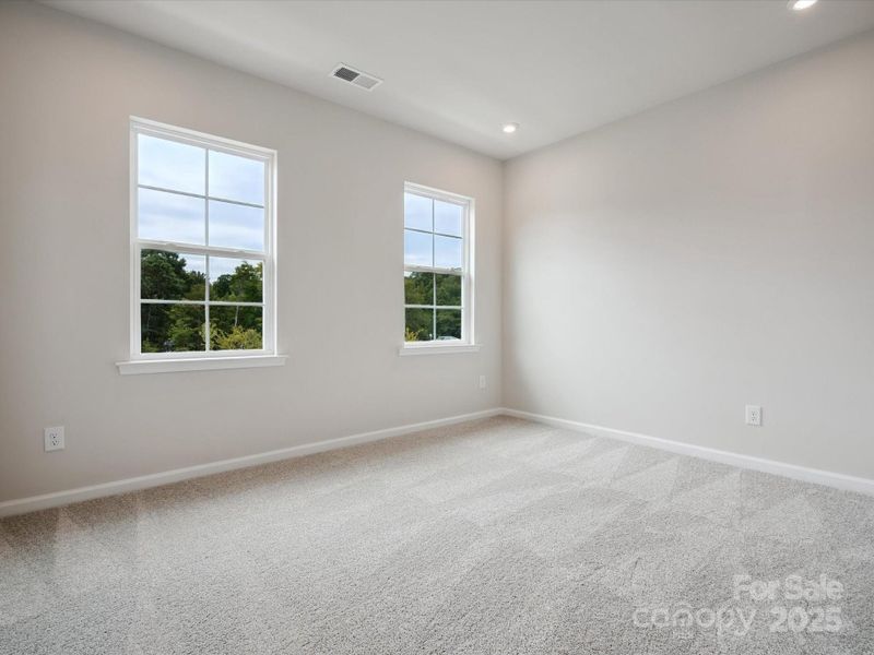 Bedroom 3 with Unobstructed Tree-Lined Views.  *Model Photos | Actual Finishes, Structural Selections, and Orientation May Vary.