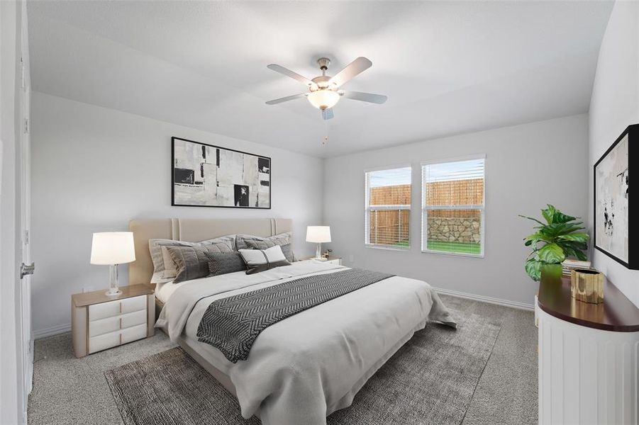 Carpeted bedroom with baseboards and a ceiling fan Carpeted bedroom with baseboards and a ceiling fan