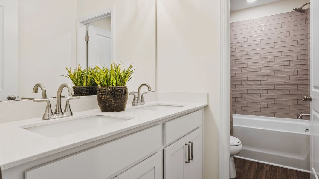 Townsend home plan secondary bathroom with dual vanities and tile shower