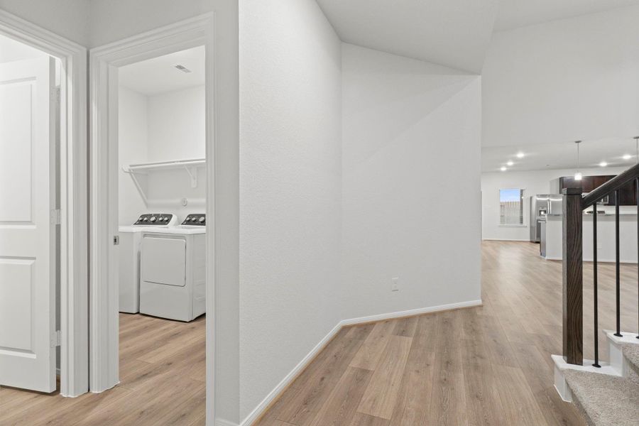The hallway connects the main level beautifully, featuring sleek finishes and subtle touches that add character. Its open flow leads effortlessly to the family room, ensuring both convenience and comfort in everyday living.