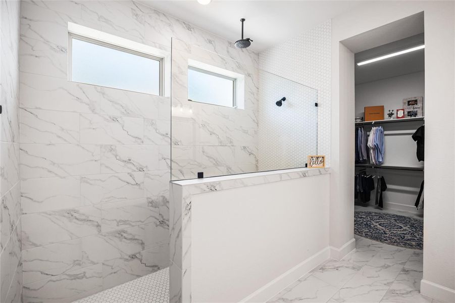 Luxurious primary bath featuring an oversized walk-in shower with a ceiling-mounted rainfall showerhead.