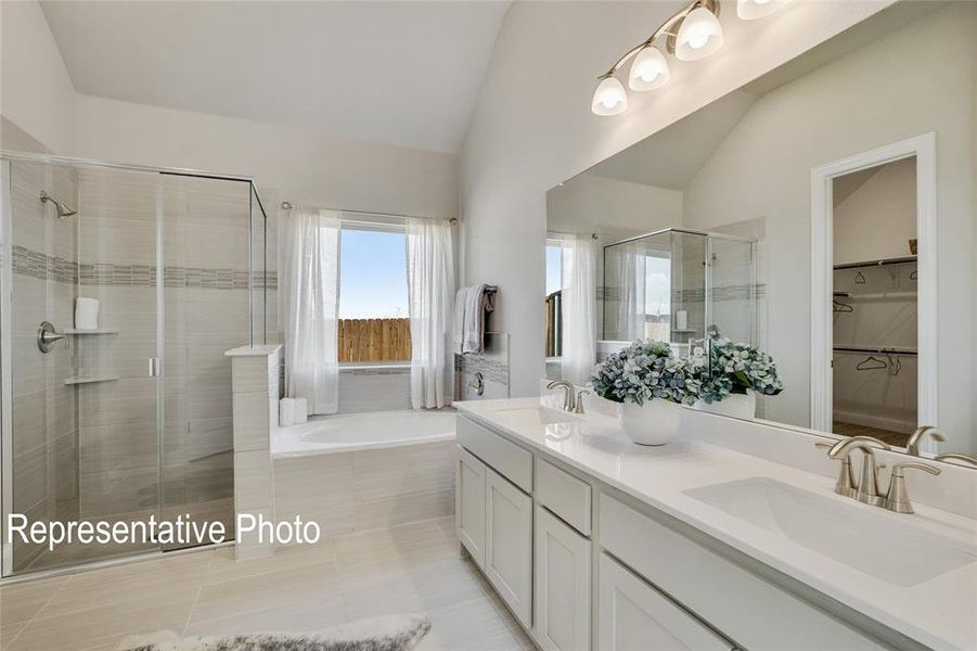 The bathroom features a glass-enclosed shower, a separate bathtub beneath a window, and a double vanity with two sinks