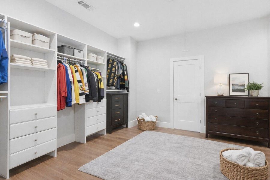 Walk in closet featuring light wood-style flooring