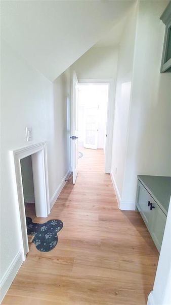 Corridor with light hardwood / wood-style floors