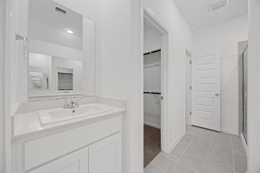 Primary Bathroom in the Cypress home plan by Trophy Signature Homes – REPRESENTATIVE PHOTO