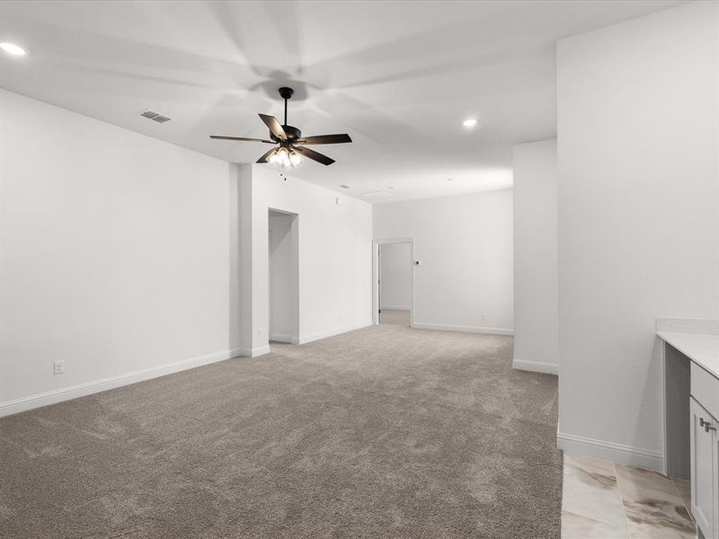 Unfurnished room featuring recessed lighting, light colored carpet, and a ceiling fan