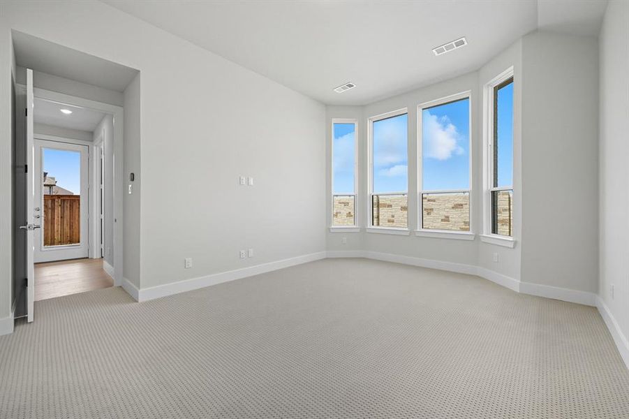 Spare room featuring carpet flooring and baseboards Spare room featuring carpet flooring and baseboards