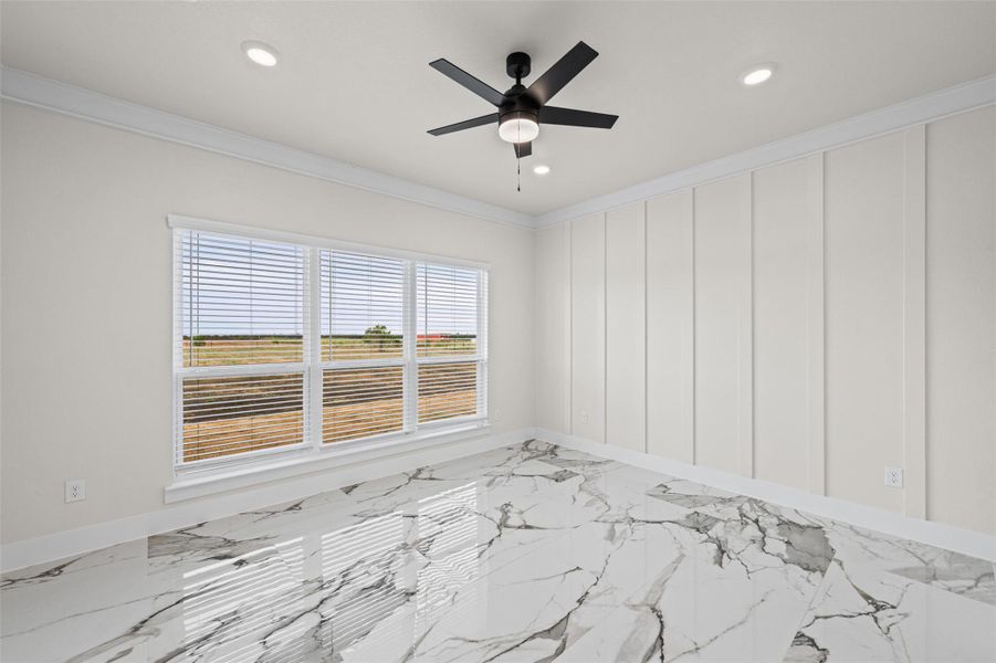 Gleaming polished tile floors and board-and-batten wall detailing define this versatile bedroom space.