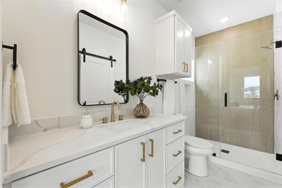 How dreamy is this! The ensuite bath features a quartz vanity, walk-in shower, fluted accent tile, and a spacious walk-in closet! How dreamy is this! The ensuite bath features a quartz vanity, walk-in shower, fluted accent tile, and a spacious walk-in closet!