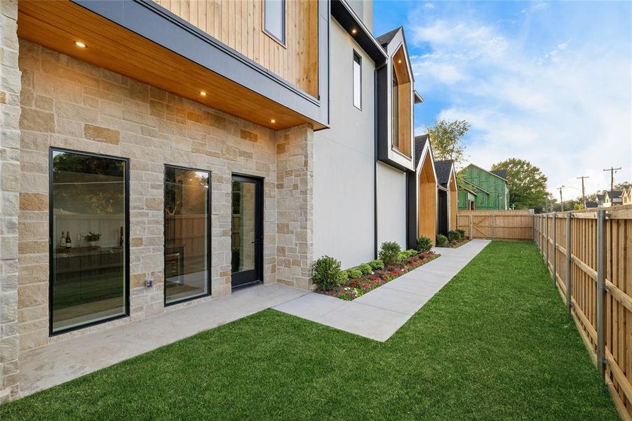 Expansive green lawn with a privacy fence Expansive green lawn with a privacy fence