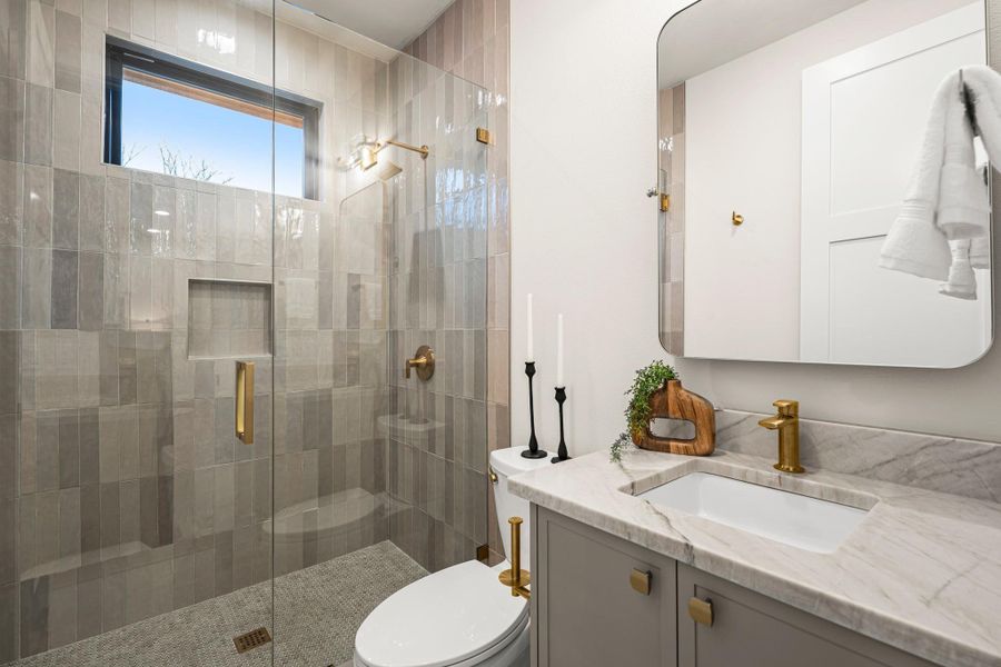 Full bathroom with vanity and a shower stall