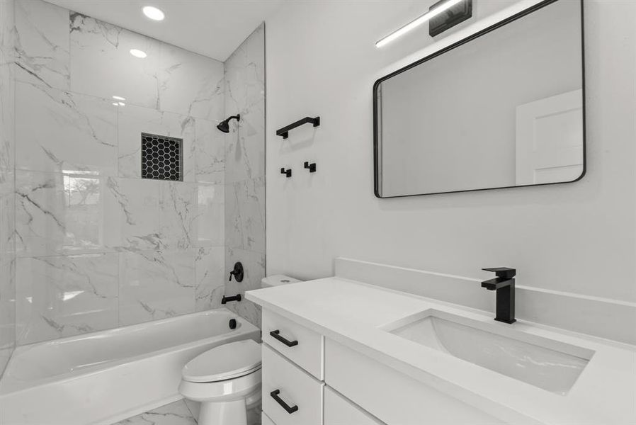 Full bathroom with bathtub / shower combination, toilet, recessed lighting, vanity, and marble finish floor