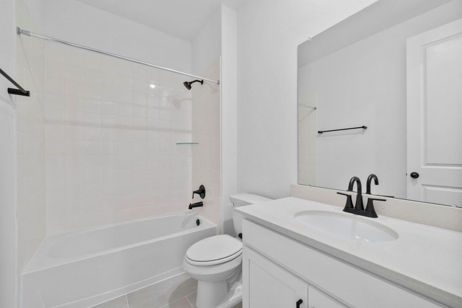 A secondary bathroom finished with clean lines and warm, timeless details that our AW Harmony Collection is known for..