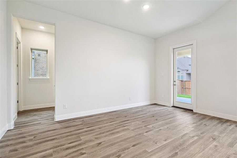 Empty room with light hardwood / wood-style floors