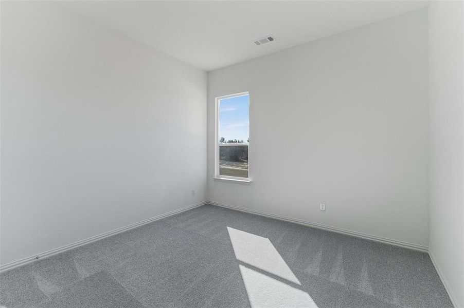 Carpeted empty room with baseboards
