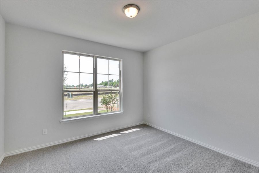 Spare room featuring carpet flooring and baseboards Spare room featuring carpet flooring and baseboards