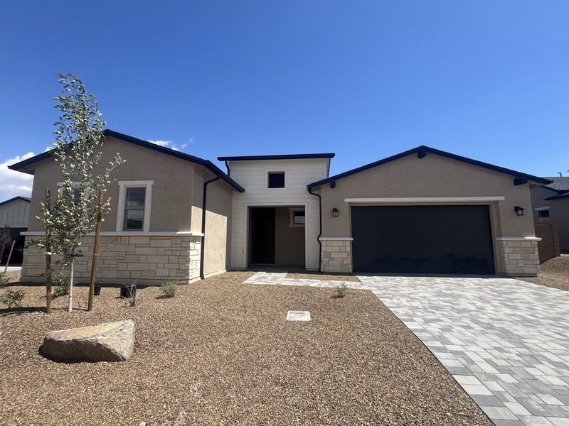 Front exterior of a new home in Overlook at The Dells, Prescott, AZ, highlighting curb appeal (Image 1). Front exterior of a new home in Overlook at The Dells, Prescott, AZ, highlighting curb appeal (Image 1).