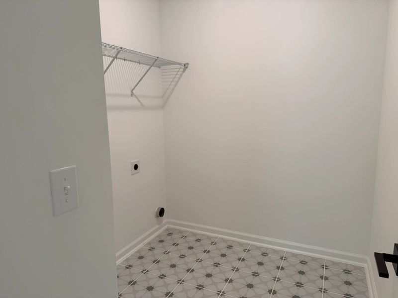 Laundry Room featuring the AW Collection® Serene - Light finishes and simple wire shelving.