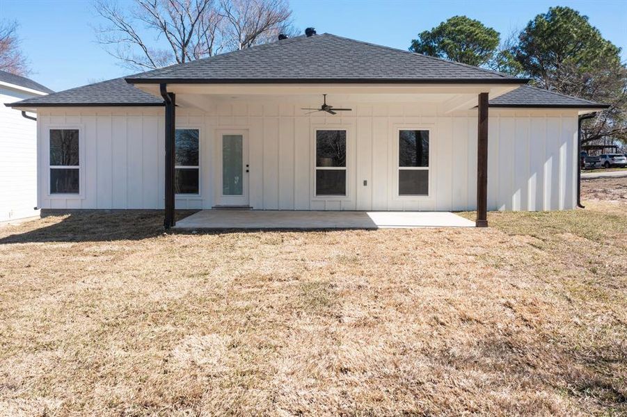 Back of property featuring a yard, ceiling fan, and a patio area