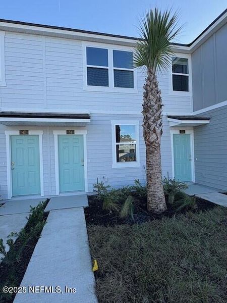 Exterior details and patio area of a home in Cordera Townhomes, St. Augustine (Image 2). Exterior details and patio area of a home in Cordera Townhomes, St. Augustine (Image 2).