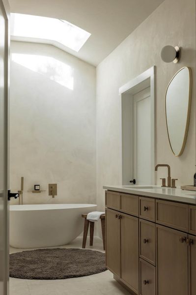 Double vanity, skylight over freestanding tub. What's a better way to relax in your secrete corner?
