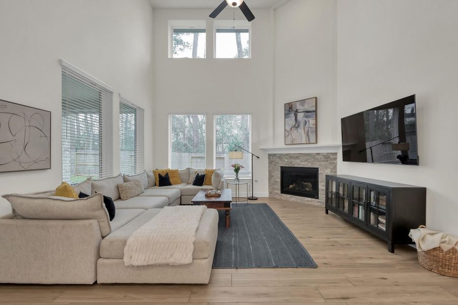 Expansive living room with soaring ceilings and natural light throughout.