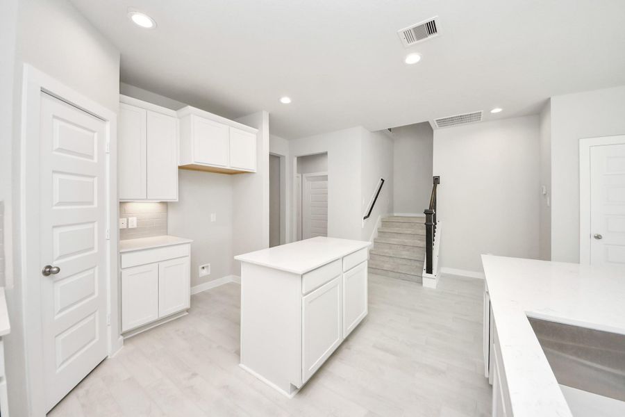 Discover another perspective of this stunning kitchen, generously appointed with an abundance of counter space Discover another perspective of this stunning kitchen, generously appointed with an abundance of counter space