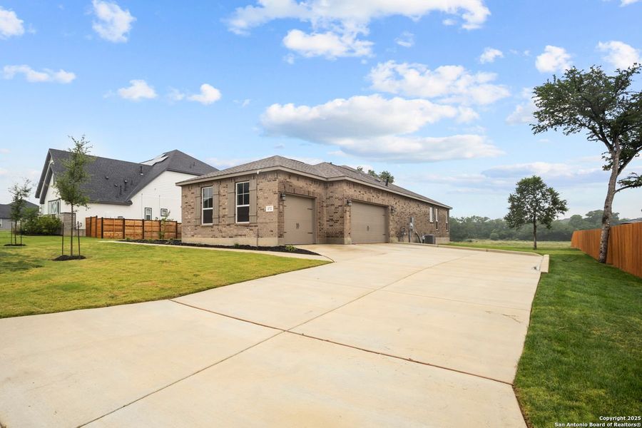 Front exterior of a new home in Potranco Oaks, Castroville, TX, highlighting curb appeal (Image 23).