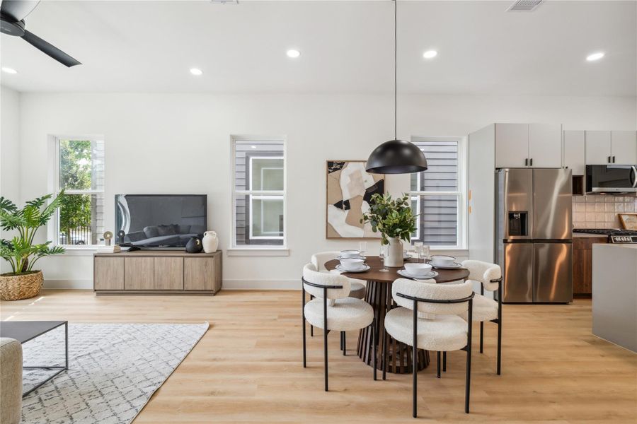 High ceilings, recessed lighting, and thoughtfully placed windows fill the open-concept living and dining space with natural light—perfect for everyday ease and effortless entertaining.