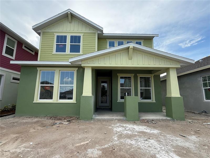 Front exterior of a new home in Laureate Park, Orlando, FL, highlighting curb appeal (Image 1). Front exterior of a new home in Laureate Park, Orlando, FL, highlighting curb appeal (Image 1).