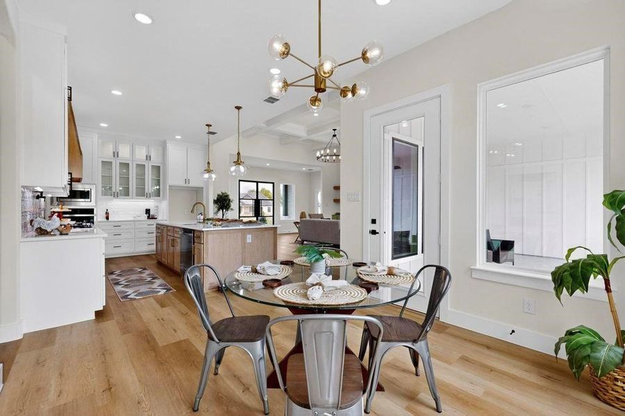 Dining area with light wood-style floors, a chandelier, recessed lighting, and beamed ceiling Dining area with light wood-style floors, a chandelier, recessed lighting, and beamed ceiling