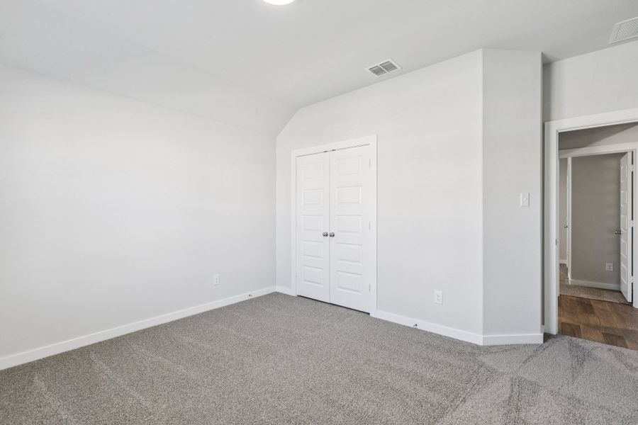 Bedroom in the Oscar home plan by Trophy Signature Homes – REPRESENTATIVE PHOTO