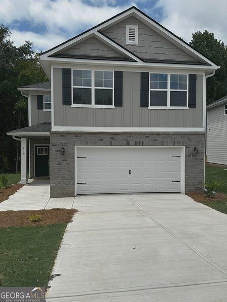 Front exterior of a new home in Canterbury Villas, Carrollton, GA, highlighting curb appeal (Image 1).