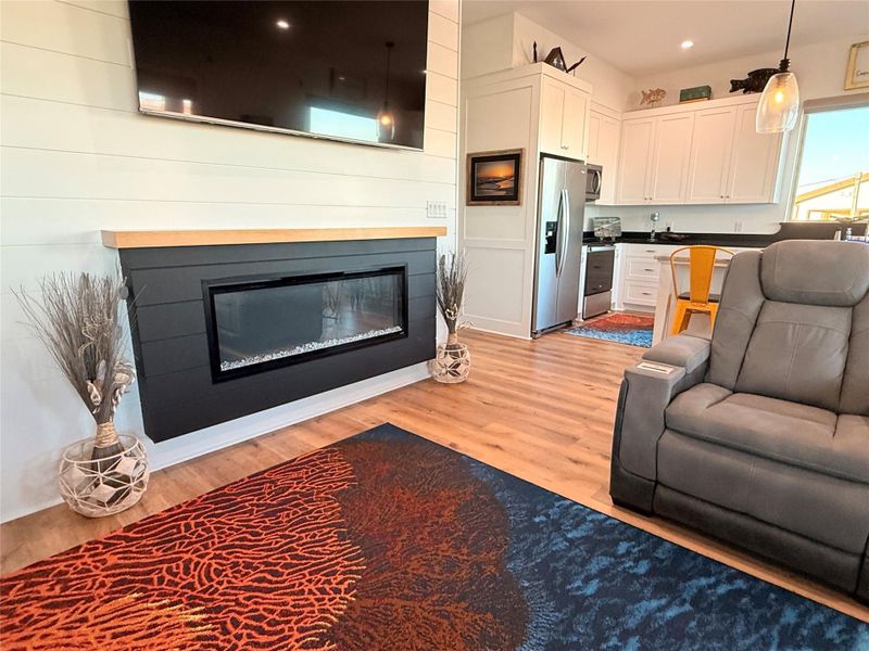 Inviting living room with Electric fireplace giving a welcoming atmosphere all year long.