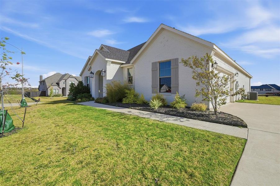 Front exterior of a new home in Wildcat Ridge, Godley, TX, highlighting curb appeal (Image 20). Front exterior of a new home in Wildcat Ridge, Godley, TX, highlighting curb appeal (Image 20).